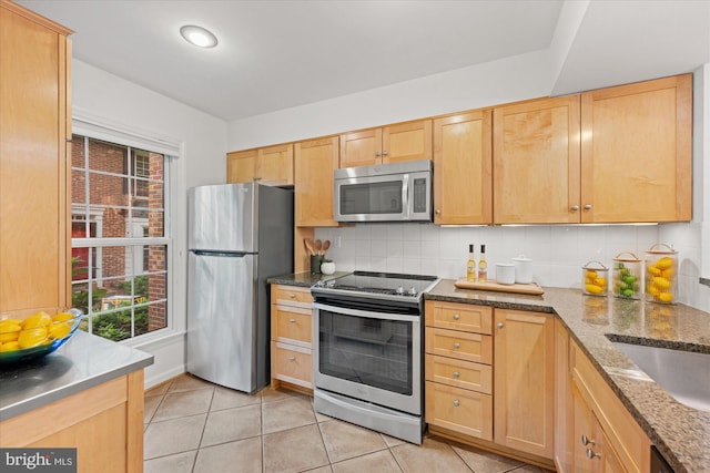2518 S Walter Reed Dr Unit B, Arlington, VA 22206 - kitchen featuring appliances with stainless steel finishes, light tile patterned flooring, tasteful backsplash, dark stone counters, and light brown cabinets