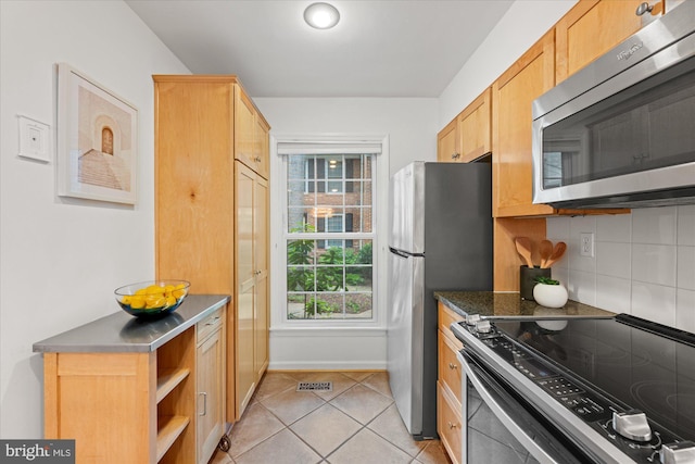 2518 S Walter Reed Dr Unit B, Arlington, VA 22206 - kitchen featuring appliances with stainless steel finishes, light tile patterned flooring, decorative backsplash, dark countertops, and open shelves