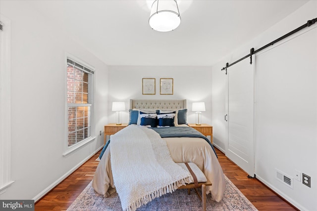 2518 S Walter Reed Dr Unit B, Arlington, VA 22206 - bedroom featuring a barn door, wood finished floors, and baseboards