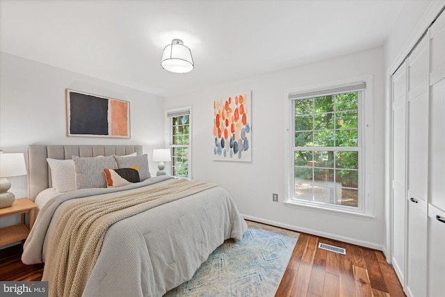 2518 S Walter Reed Dr Unit B, Arlington, VA 22206 - bedroom featuring hardwood / wood-style flooring, multiple windows, baseboards, and a closet