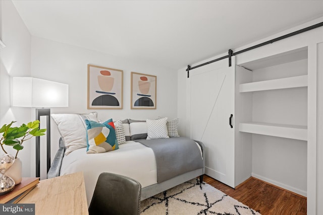 2518 S Walter Reed Dr Unit B, Arlington, VA 22206 - bedroom with a barn door, baseboards, and wood finished floors
