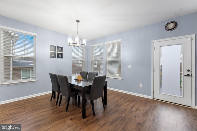 dining space featuring dark hardwood / wood-style flooring and a chandelier