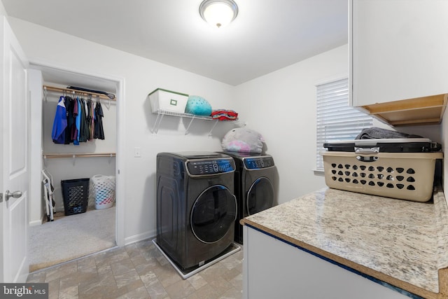 clothes washing area with light colored carpet and separate washer and dryer