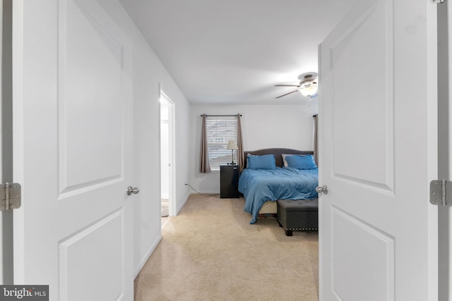 bedroom featuring ceiling fan and light colored carpet