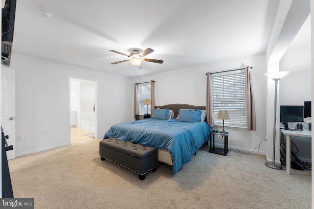 bedroom with ceiling fan, connected bathroom, and light colored carpet