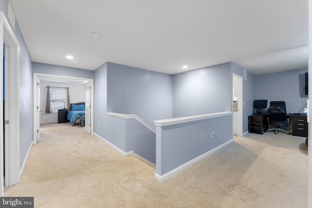 hallway featuring light carpet