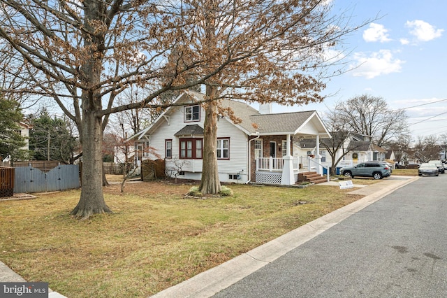 view of front facade featuring covered porch and a front yard