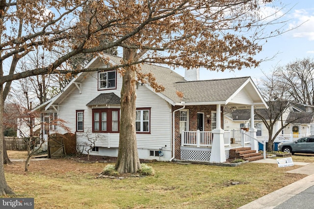 view of front of property with a porch and a front yard