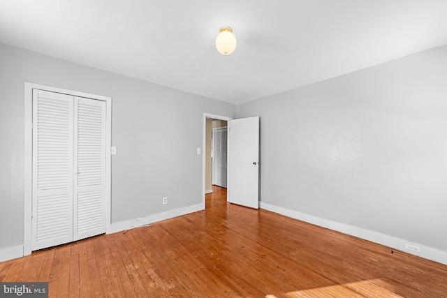 unfurnished bedroom featuring hardwood / wood-style flooring and a closet