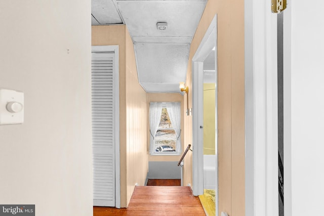 hallway featuring wood-type flooring and a textured ceiling