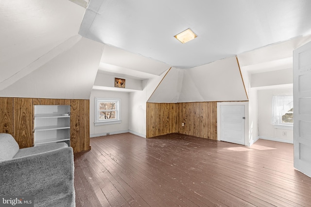 bonus room with hardwood / wood-style flooring, a wealth of natural light, and lofted ceiling