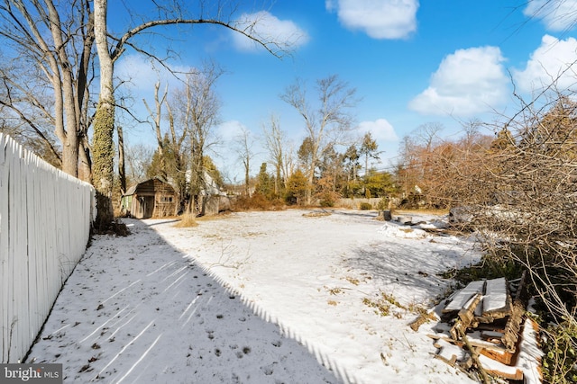 yard covered in snow with an outdoor structure