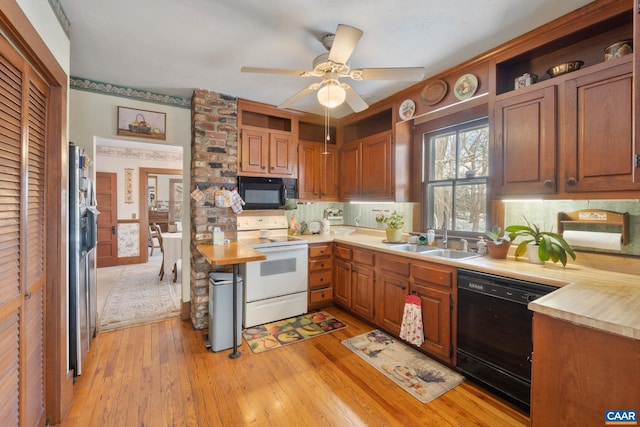 kitchen featuring black appliances, sink, light hardwood / wood-style flooring, ceiling fan, and tasteful backsplash