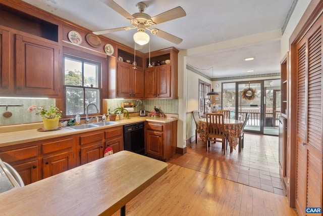 kitchen with ceiling fan, sink, black dishwasher, decorative backsplash, and light wood-type flooring