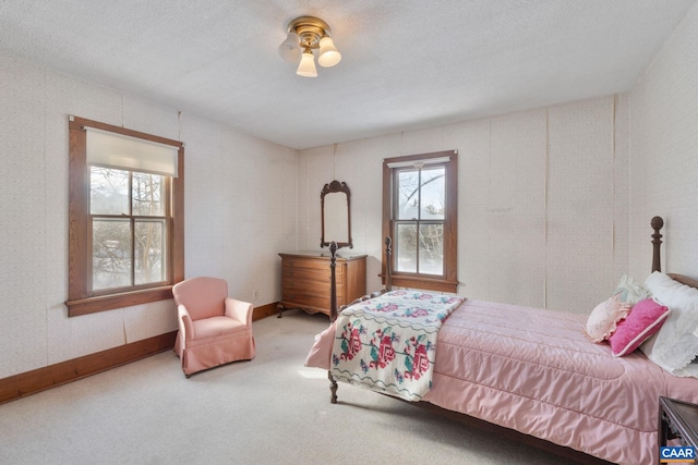 bedroom featuring carpet floors and a textured ceiling