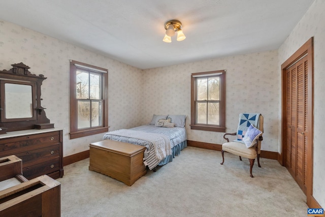 bedroom with light colored carpet and a closet