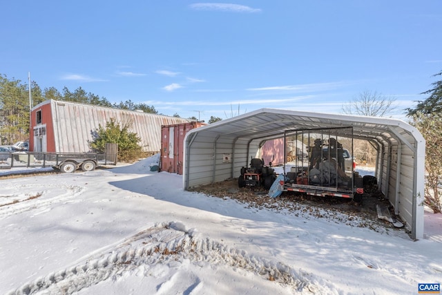 snow covered parking with a carport