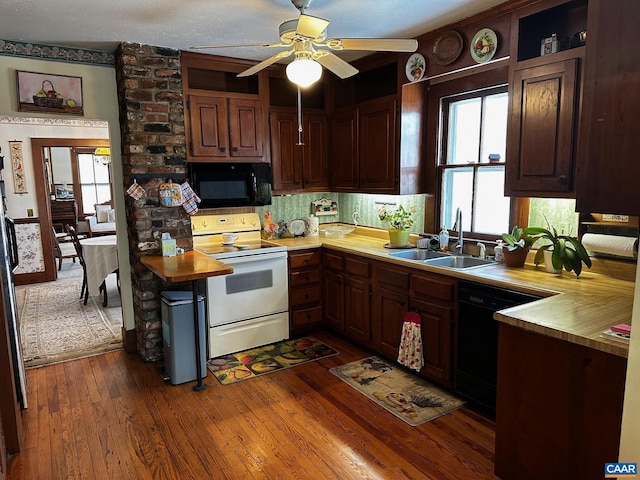 kitchen featuring dark brown cabinetry, ceiling fan, dark wood-type flooring, sink, and black appliances