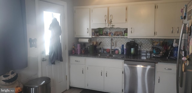 kitchen with white cabinets, dishwasher, decorative backsplash, and sink