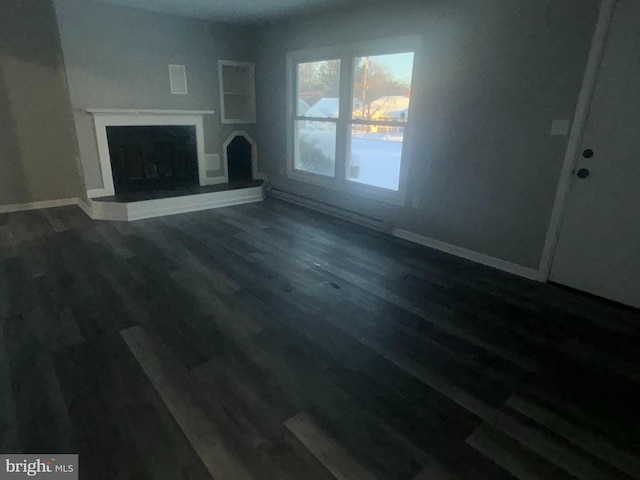 unfurnished living room with wood-type flooring