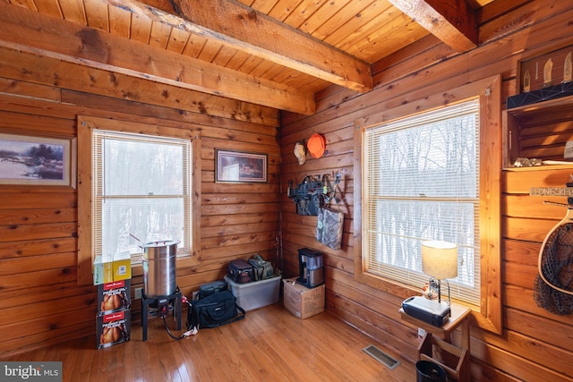 misc room with beamed ceiling, light hardwood / wood-style flooring, and wooden ceiling