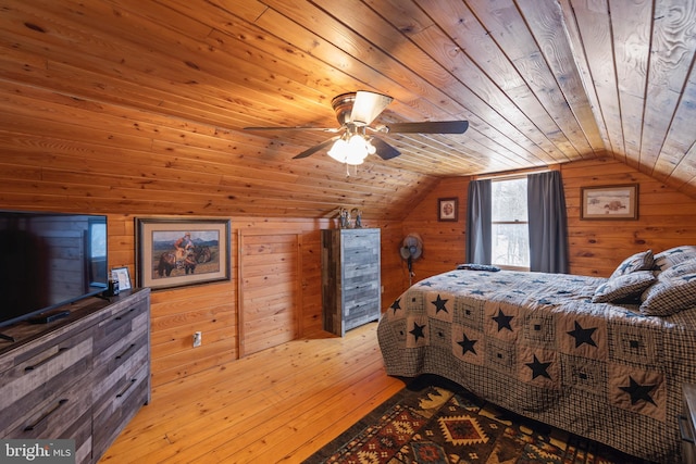 bedroom featuring vaulted ceiling, ceiling fan, wood walls, and wood ceiling