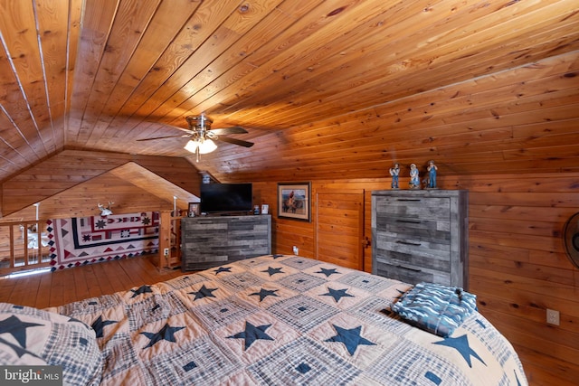 bedroom featuring hardwood / wood-style floors, wooden walls, vaulted ceiling, ceiling fan, and wood ceiling