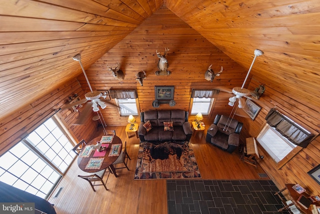 unfurnished living room with wooden walls, lofted ceiling, and wood ceiling