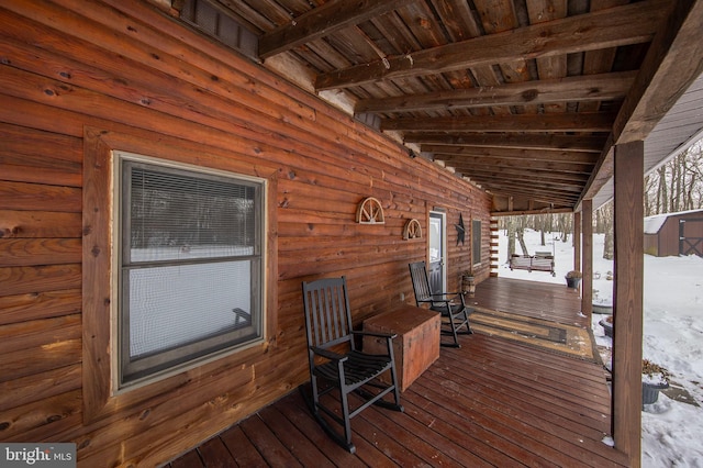 snow covered deck with covered porch