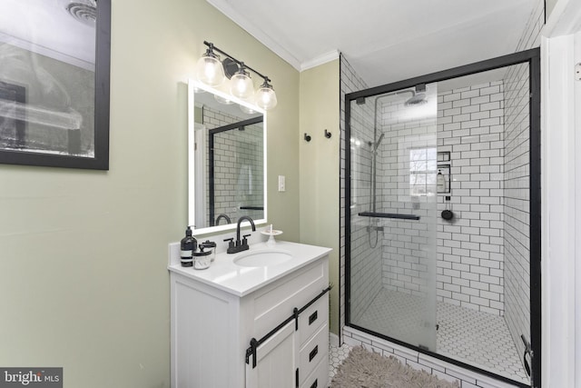 bathroom featuring vanity, a shower with door, and ornamental molding