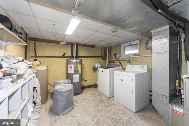 laundry room featuring water heater and independent washer and dryer