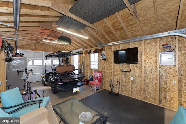 garage featuring stainless steel fridge and electric panel