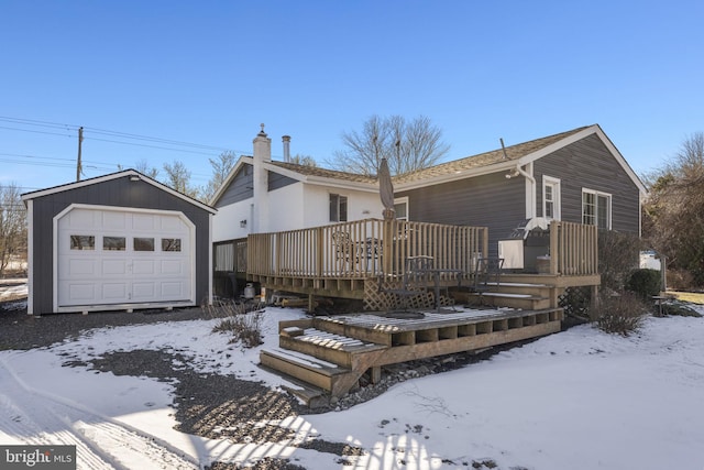 single story home featuring a wooden deck, an outdoor structure, and a garage