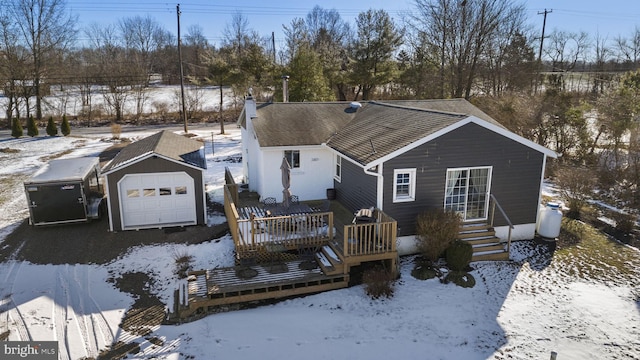 view of front of home with an outbuilding, a garage, and a wooden deck