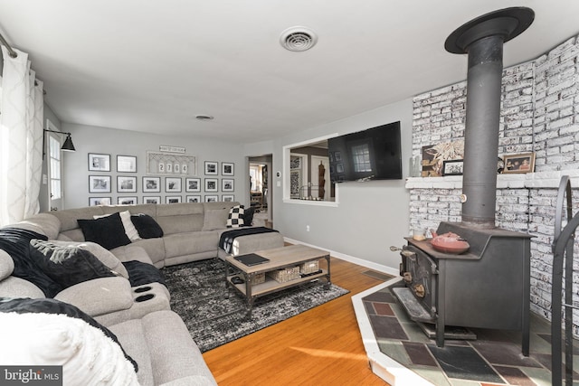 living room featuring hardwood / wood-style flooring and a wood stove