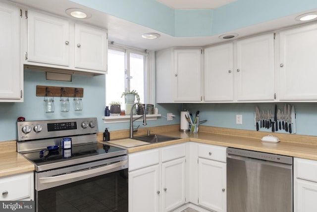 kitchen featuring white cabinetry, sink, and stainless steel appliances