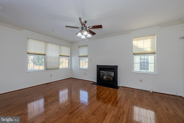 unfurnished living room with ornamental molding, hardwood / wood-style floors, and ceiling fan