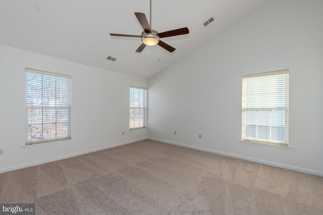 carpeted spare room featuring ceiling fan and high vaulted ceiling