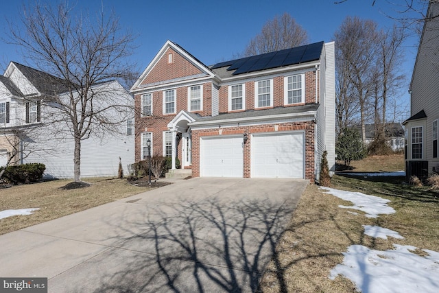 view of front of home with a garage and solar panels