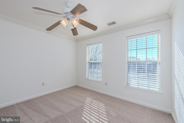 spare room with ornamental molding, light carpet, and ceiling fan