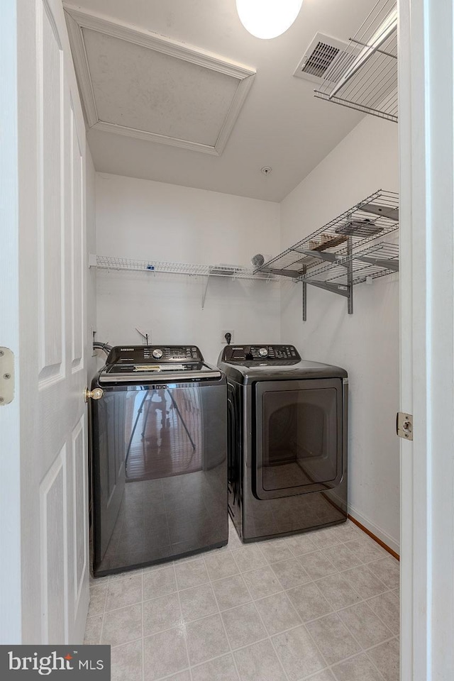 clothes washing area featuring separate washer and dryer