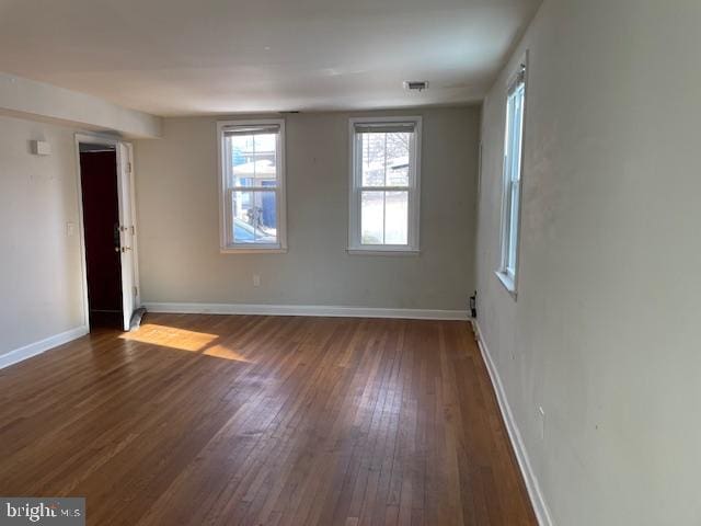 empty room with dark hardwood / wood-style floors