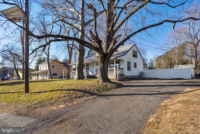 view of front of house with a porch and a front lawn