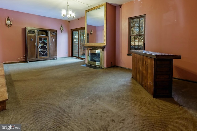 unfurnished living room with light colored carpet and a chandelier