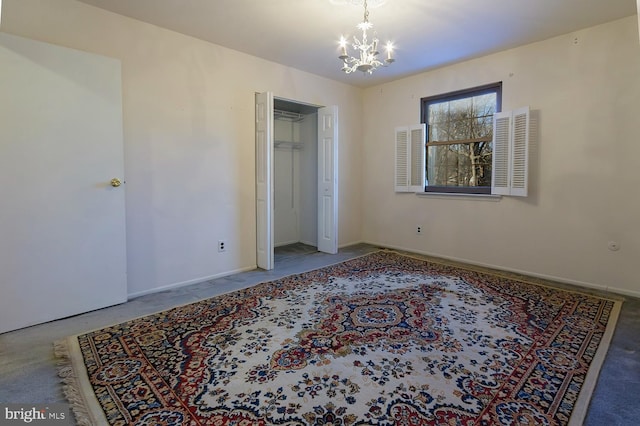 unfurnished bedroom featuring an inviting chandelier and carpet flooring