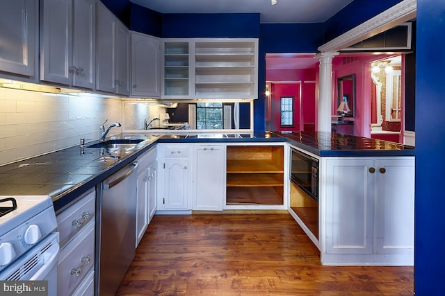 kitchen with sink, decorative columns, dark hardwood / wood-style floors, white cabinets, and stainless steel dishwasher