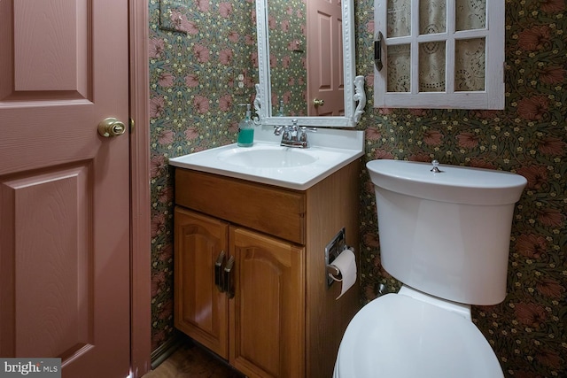 bathroom featuring vanity and toilet