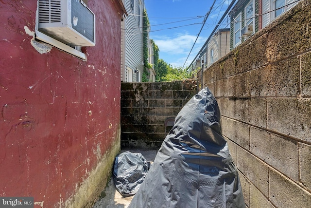 view of side of property featuring a wall mounted AC