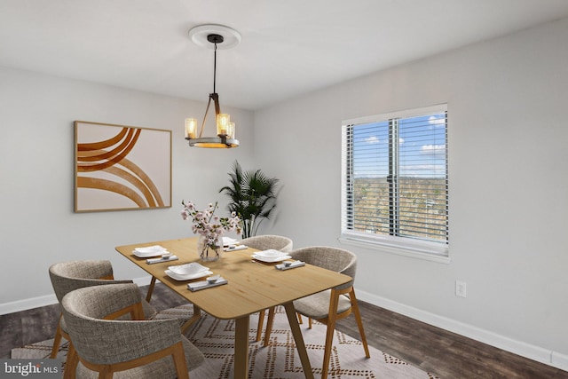 dining area with an inviting chandelier and dark hardwood / wood-style floors