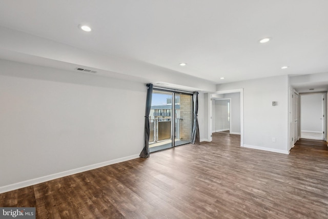 empty room with dark hardwood / wood-style floors